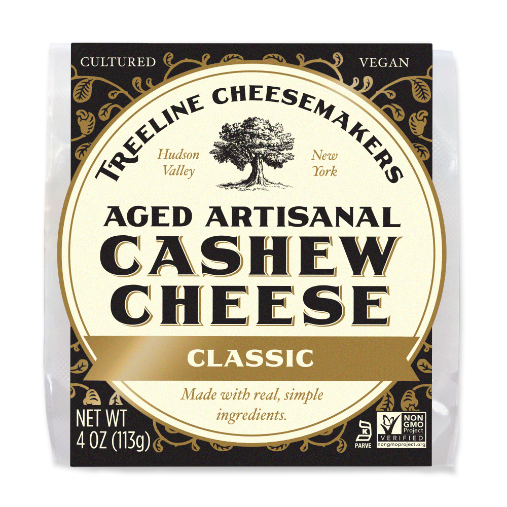a black and cream package of Treeline Vegan Classic Aged Artisanal Cashew Cheese Wheel