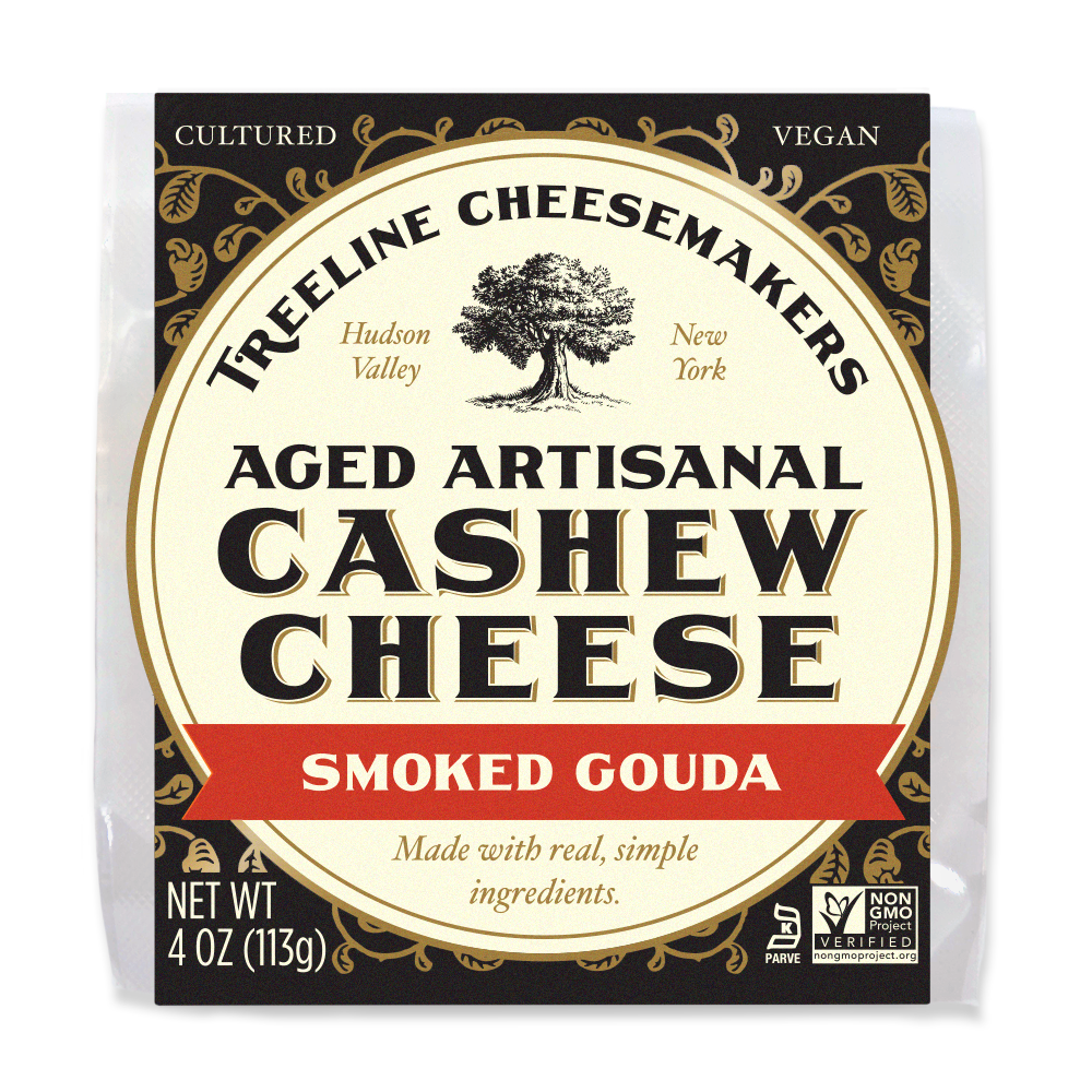 a black and cream package of Treeline Vegan Smoked Gouda Aged Artisanal Cashew Cheese Wheel