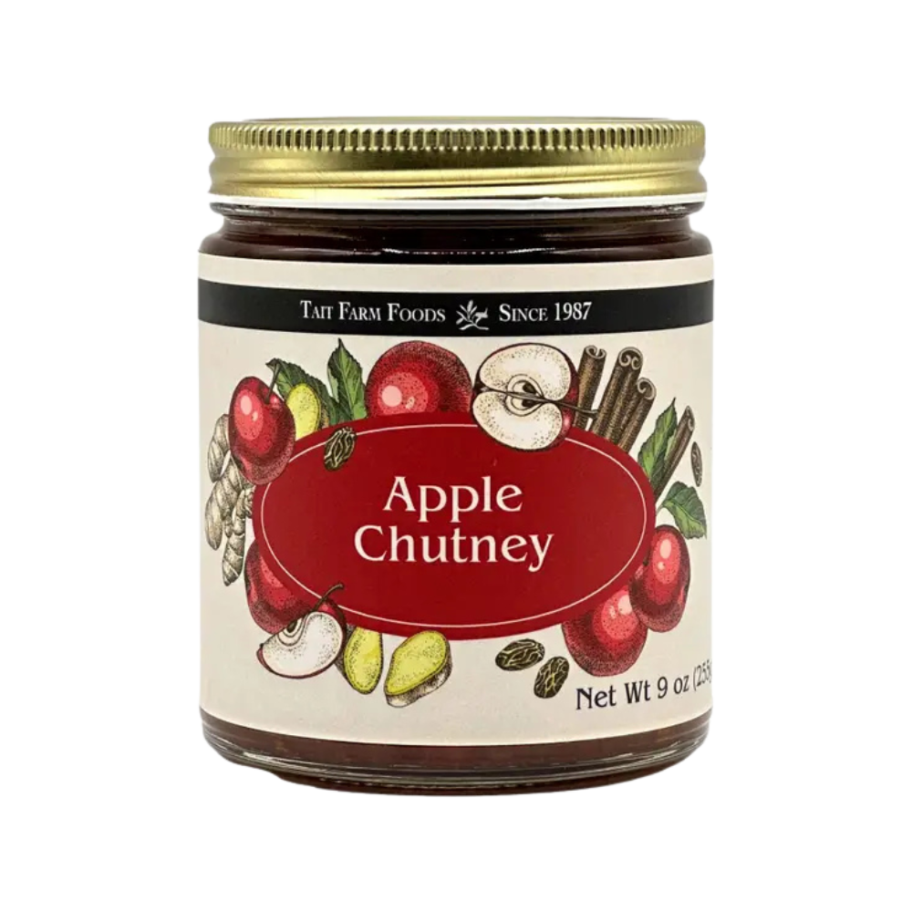 a glass jar with a red and cream label for Tait Farm Foods Apple Chutney