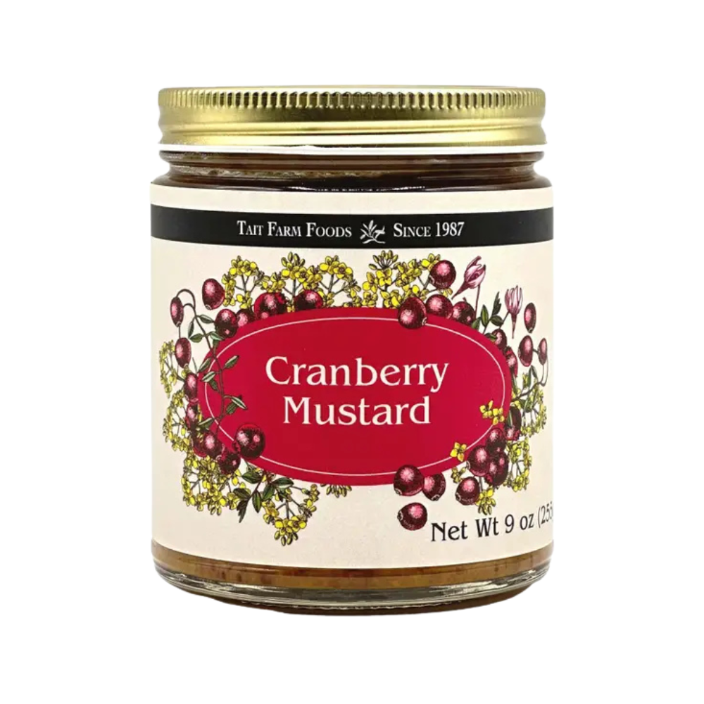 a glass jar with a red and cream label for Tait Farm Foods Cranberry Mustard