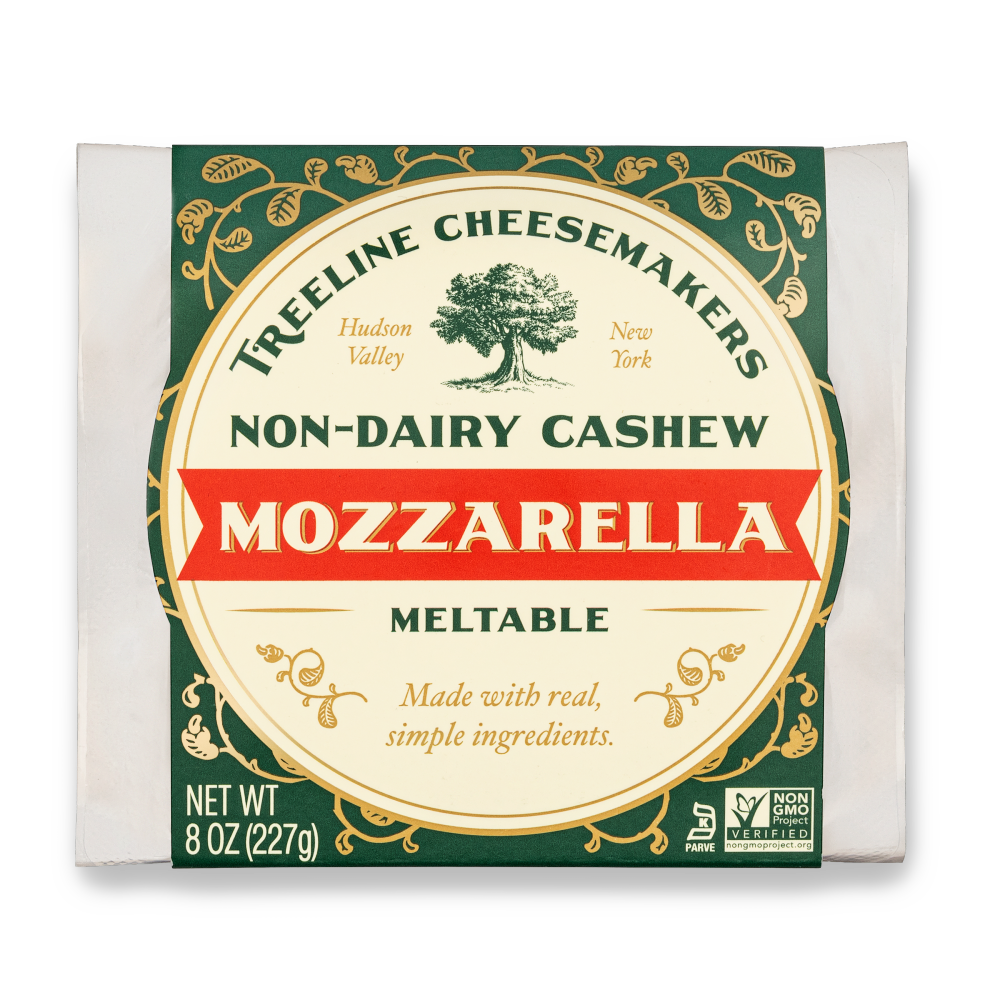 a green and cream package of Treeline Non-Dairy Cashew Mozzarella Block